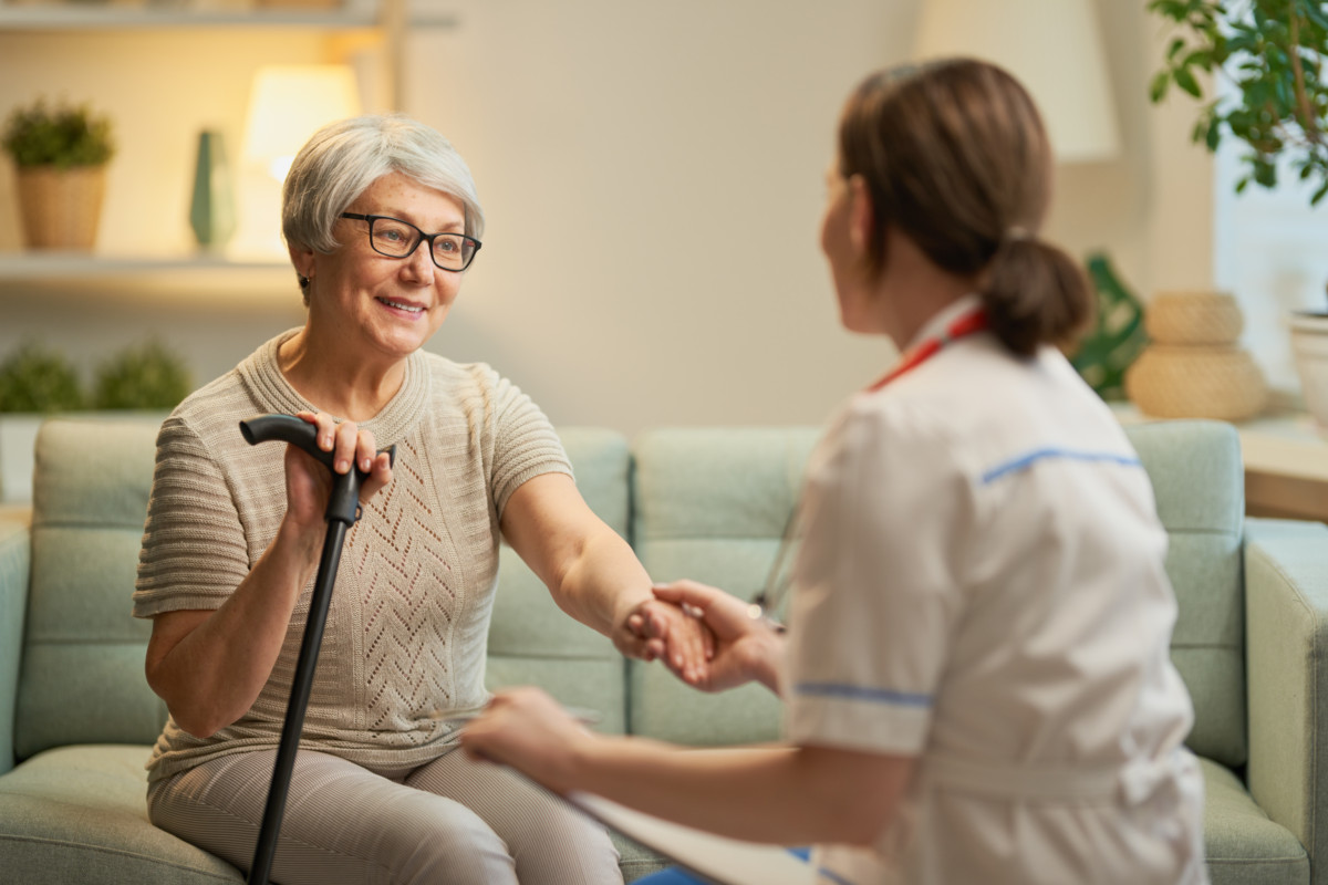 Nurse smiling with a patient during a home visit